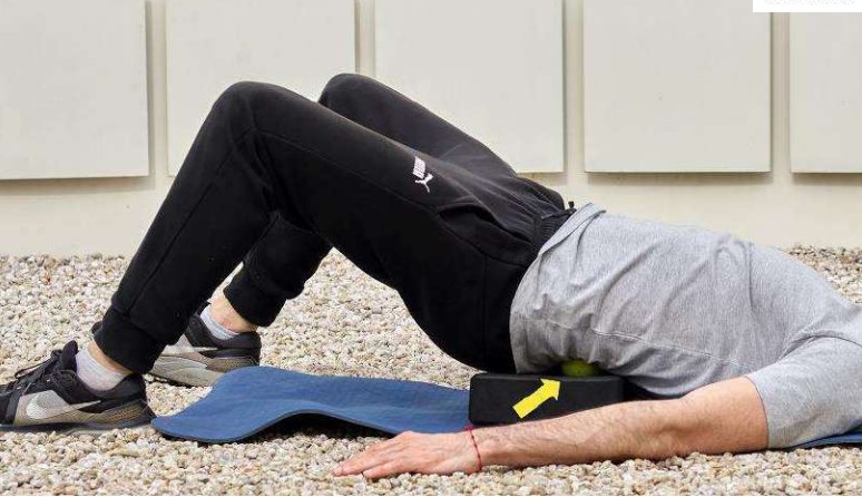 Myofascial release du carré des lombes avec deux balles de tennis